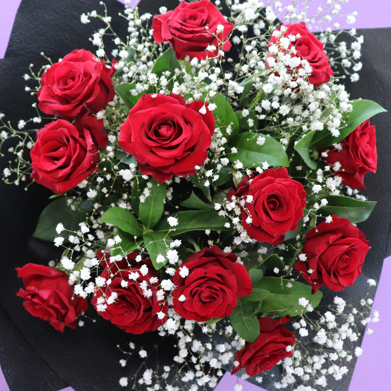 A luxury rose bouquet arrangement featuring fresh, velvety red roses, perfect for anniversaries and celebrations.