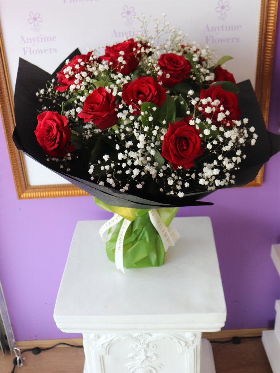 A classic twelve-rose arrangement in a decorative bouquet, perfect for expressing heartfelt emotions.