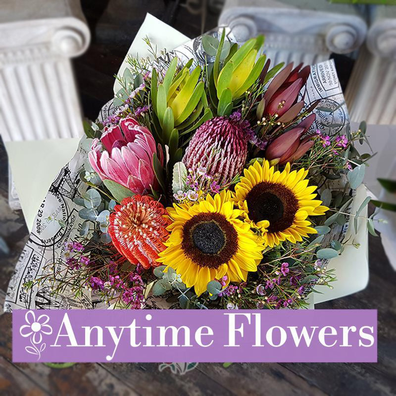 A stunning bouquet featuring sunflowers, proteas, and banksias with complementary greenery.