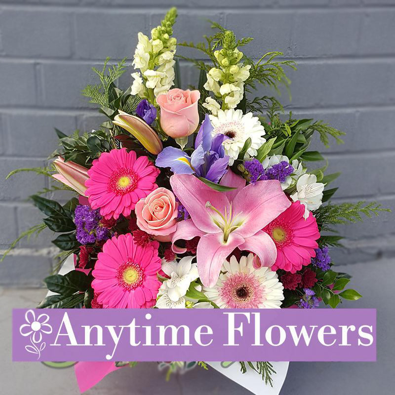 A harmonious pink arrangement with lilies, gerberas, and roses.