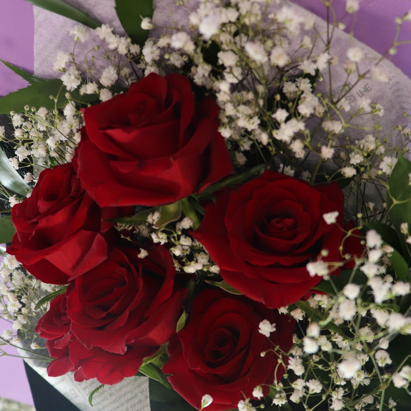 A delicate bouquet arrangement with fresh red roses, perfect for a heartfelt gift on Valentine's Day.
