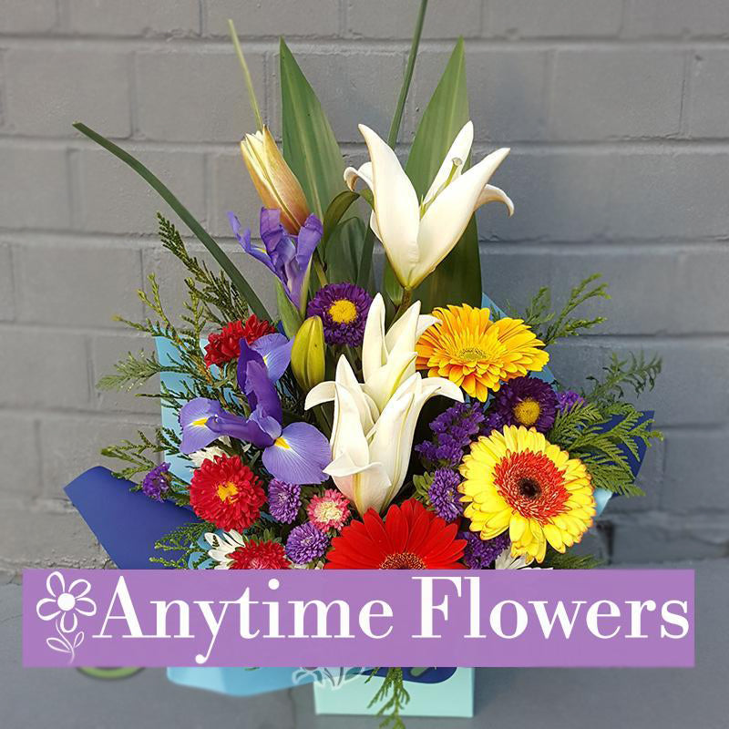 A bright and sunny bouquet with gerberas, lilies, and irises.