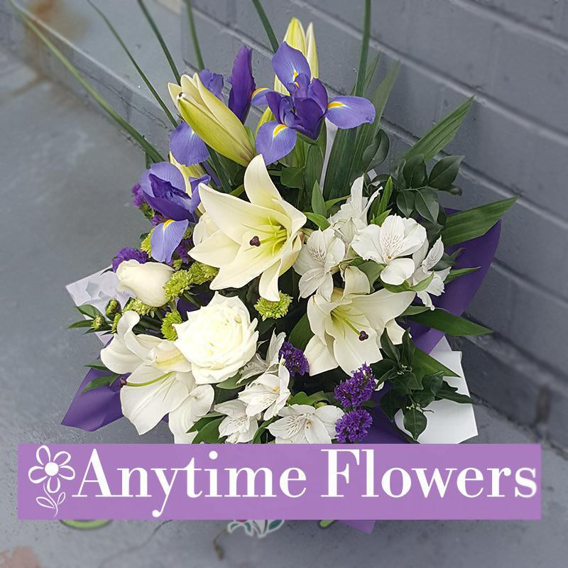 A refined bouquet with white lilies, irises, and roses.
