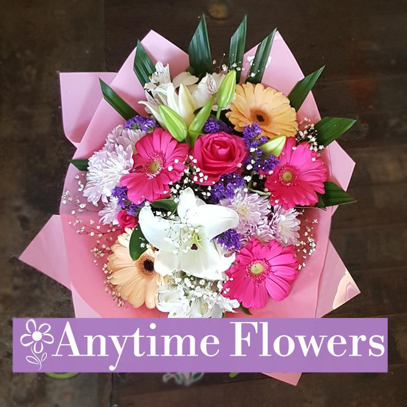 A stunning bouquet with pink gerberas, roses, and lilies.