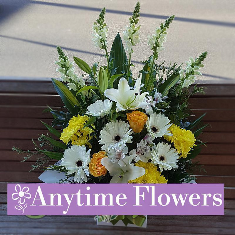A cheerful bouquet with yellow chrysanthemums, white gerberas, and yellow roses.