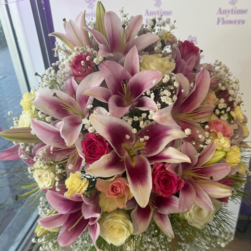 Many pink lilies and yellow roses