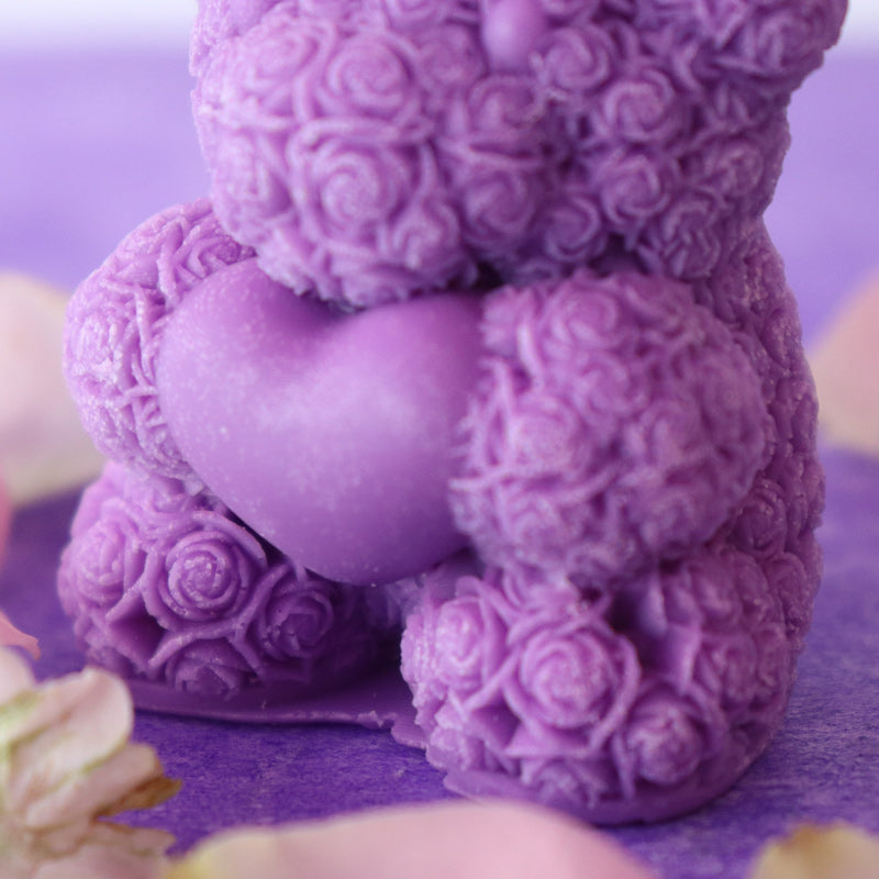 Teddy bear candle holding a heart