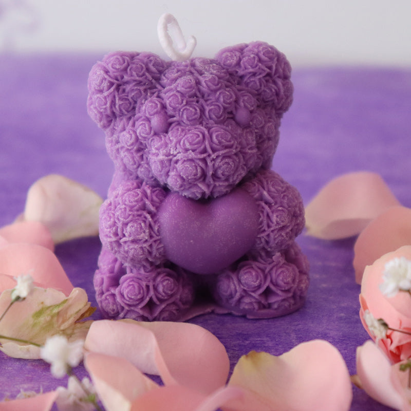 Teddy bear candle holding a heart