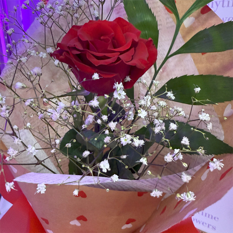 A luxurious floral bouquet with a 60cm deep red rose, elegantly arranged and ready for gifting to a loved one.