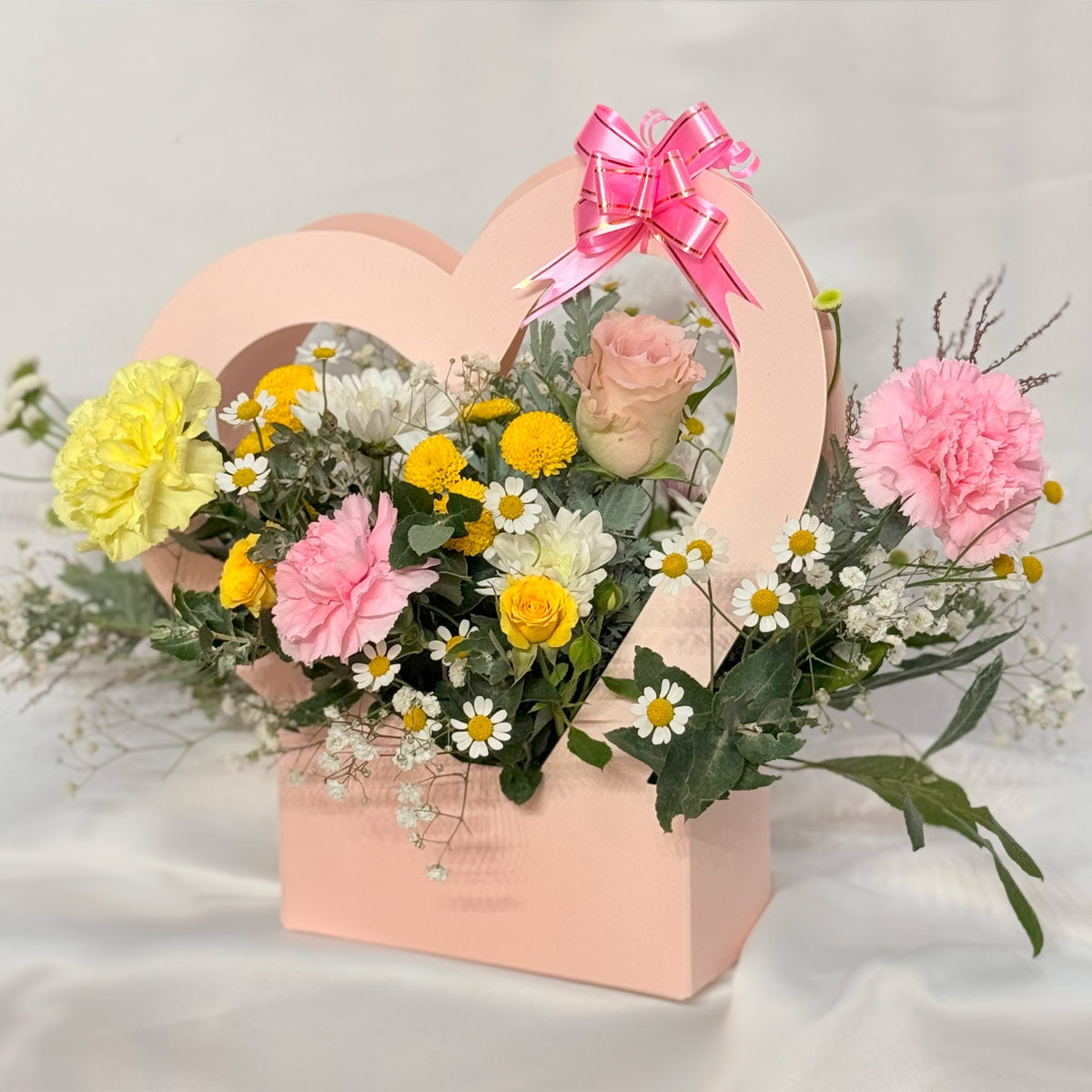 Butterfly garden flower arrangement in heart basket