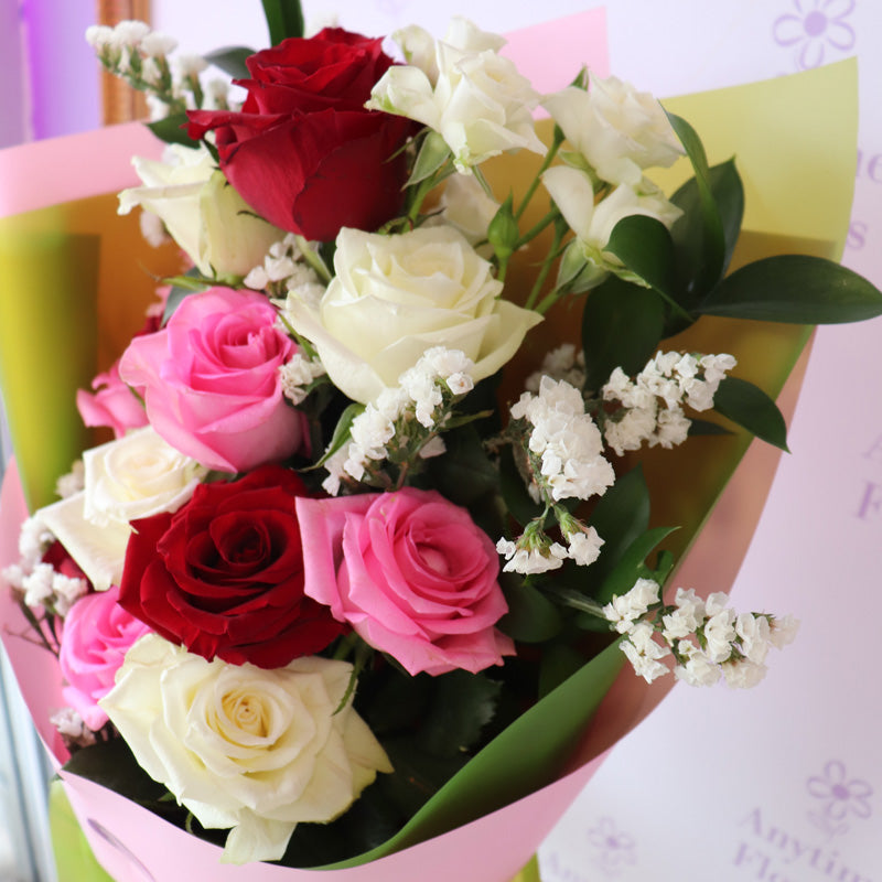 A top-down view of a stunning floral bouquet filled with perfectly arranged red, pink and white roses, ideal for special moments.