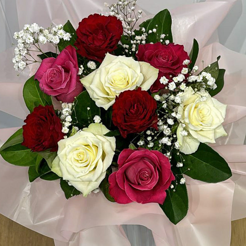Top-down view of the Love in Bloom Box, displaying the intricate floral arrangement of romantic roses and airy baby’s breath.