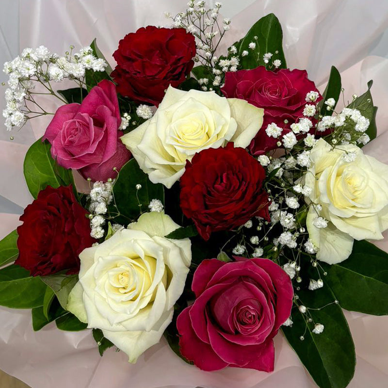 Close-up of the Love in Bloom Box, highlighting the rich textures of velvety red roses, soft white blooms, and delicate pink roses.