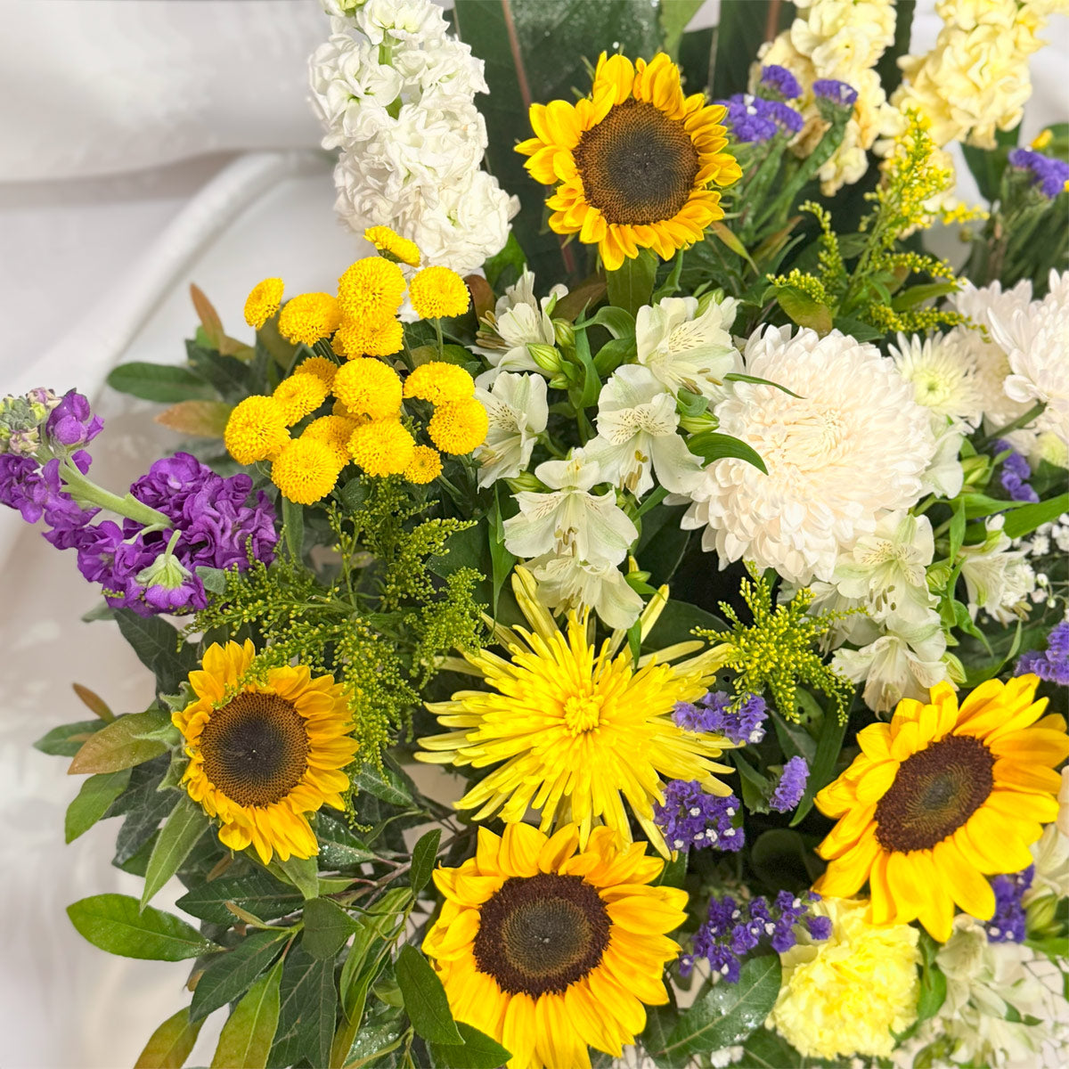 close up of Sunflowers, chrysanthemums and lilies in a bright arrangement
