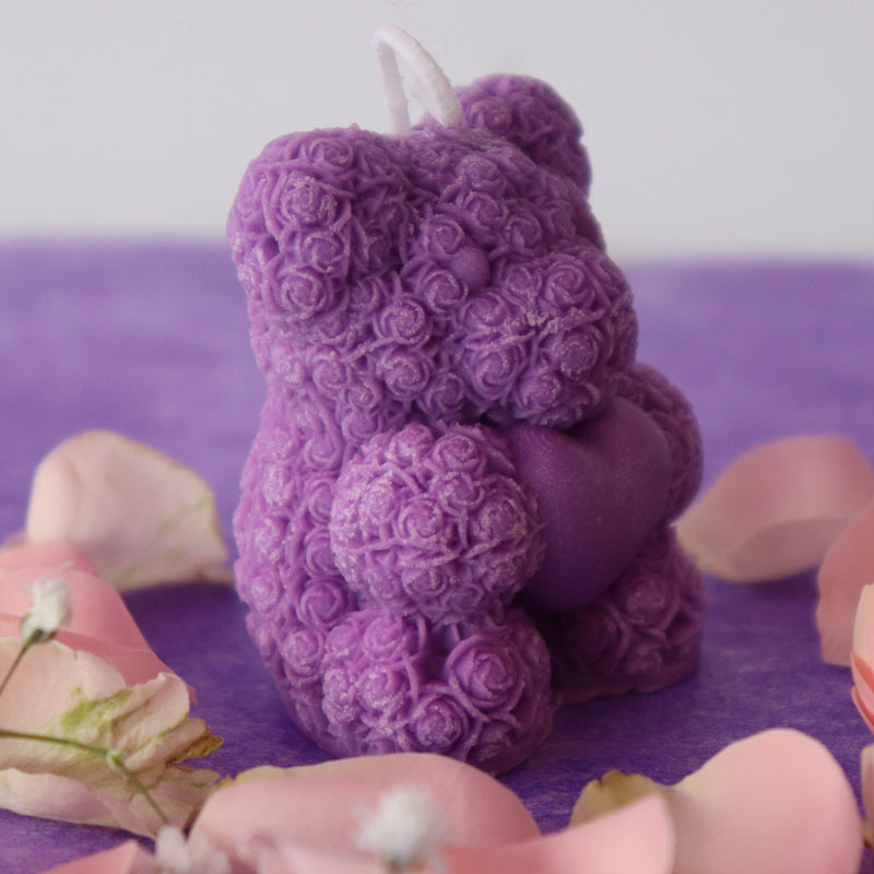 Teddy bear candle holding a heart